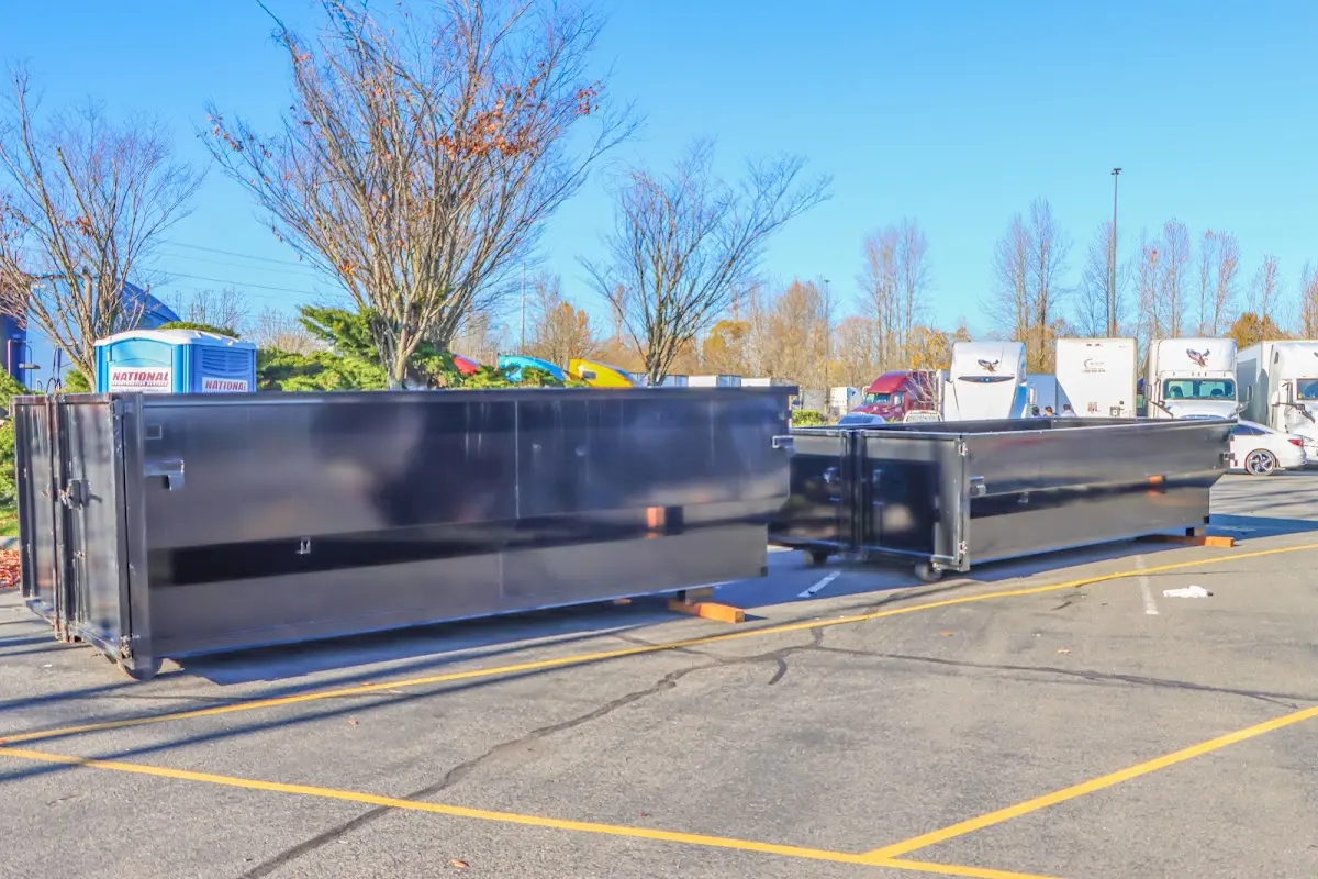 Professional dumpster rental service with roll-off container on residential driveway in Glen Rock